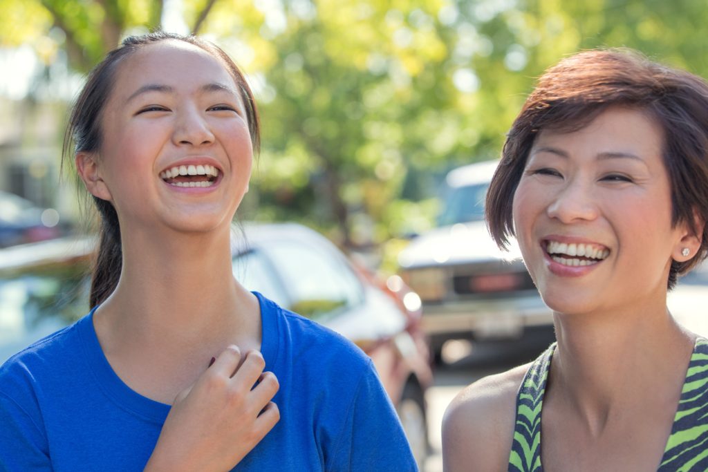 Two friends enjoy a laugh. The stress-reducing benefits of laughter are also good for your gut microbiome. Live, laugh and love. That’s one of my life mottos!