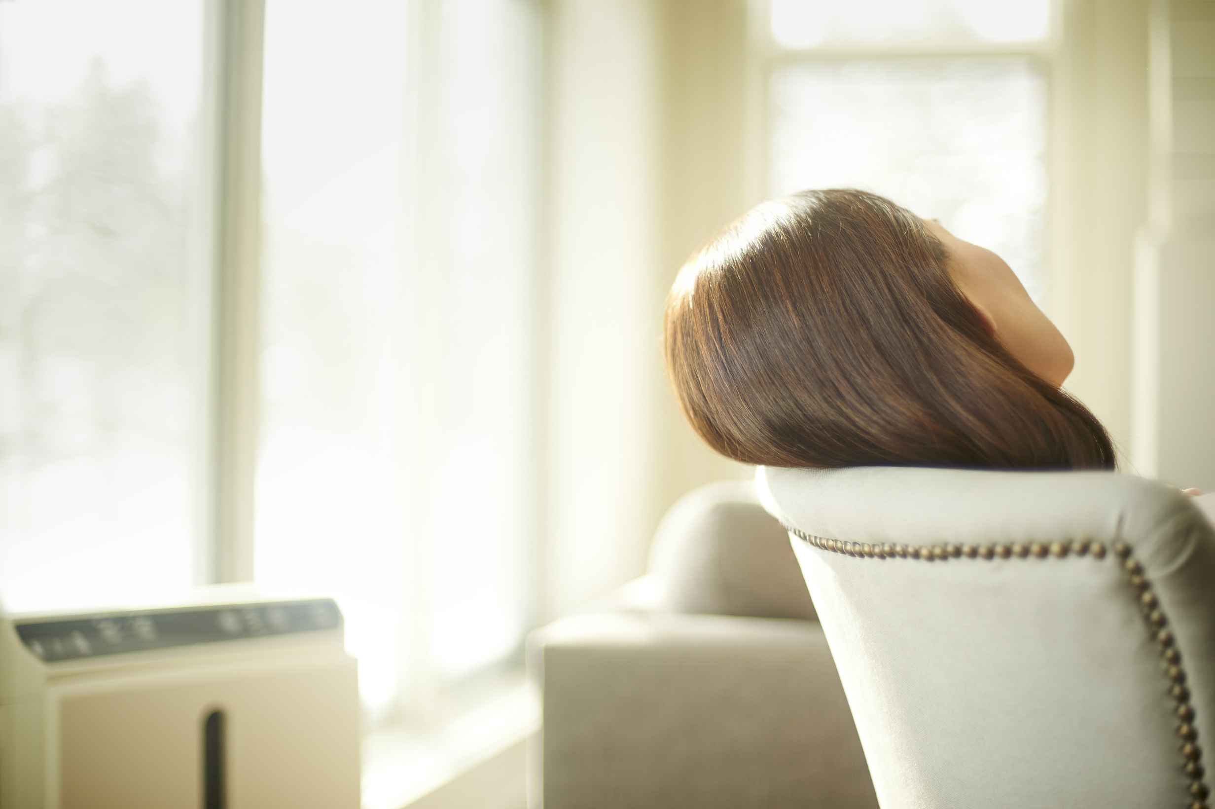 A woman taking a nap. If you find yourself needing a nap before 11am, it is a good sign that you didn’t get enough sleep or quality of sleep the night before.