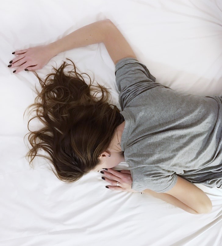 Woman asleep on bed. No question about it night of restorative sleep is like gold, and makes you feel like you can conquer the world.