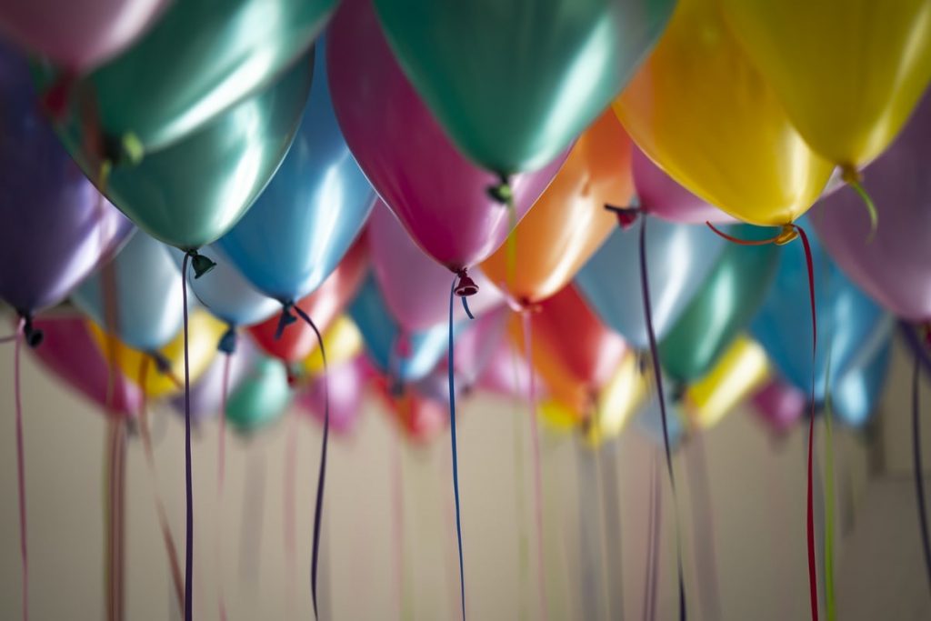 Festive balloons fill a room, perfect for a birthday celebration. Longtime Amway Business Owner Don Hitzel just celebrated his 100th birthday.