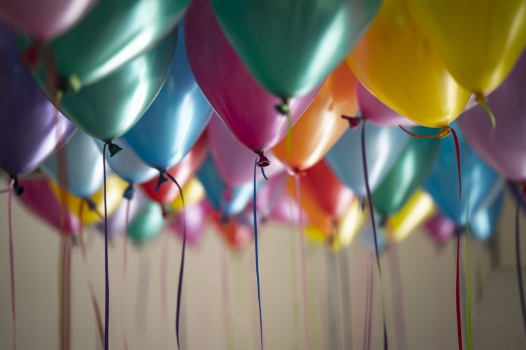 Festive balloons fill a room, perfect for a birthday celebration. Longtime Amway Business Owner Don Hitzel just celebrated his 100th birthday.