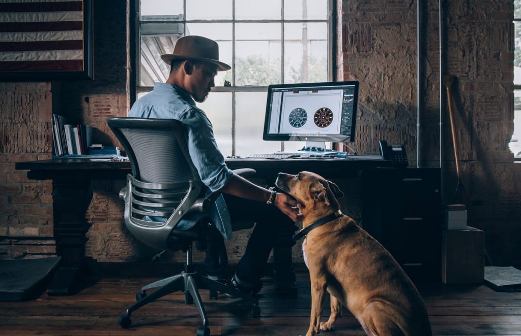 Young man sits in front of computer. To protect your eyesight, make sure to take breaks from looking at the screen.