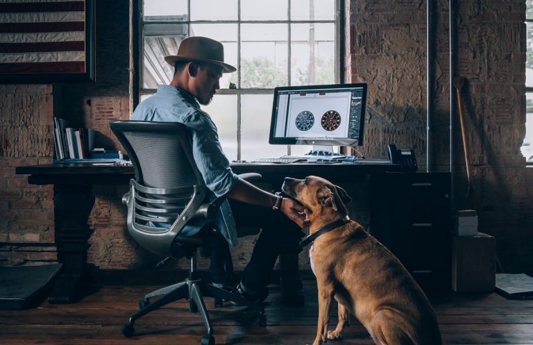 Young man sits in front of computer. To protect your eyesight, make sure to take breaks from looking at the screen.