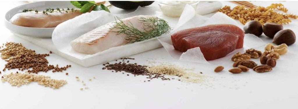 An assortment of foods, including meat, fish, poultry, legumes and whole grains, which are a good source of zinc.