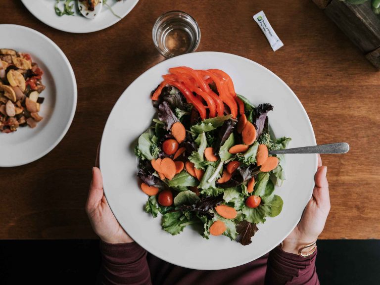 A green salad with assorted vegetables. Many vegetables are a natural source of inulin, chicory root and other beneficial prebiotics that help activate the production of beneficial bacteria in the gut.