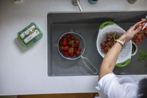 A bowl of cereal topped with fruit. Mealtime is an ideal reminder to take your supplements.