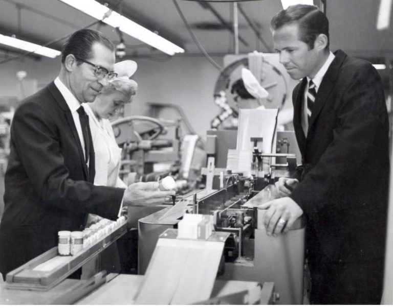 Stefan Tenkoff, Ph.D. inspects a product coming off a packaging line as I look on. Buena Park, Calif. Circa 1965.