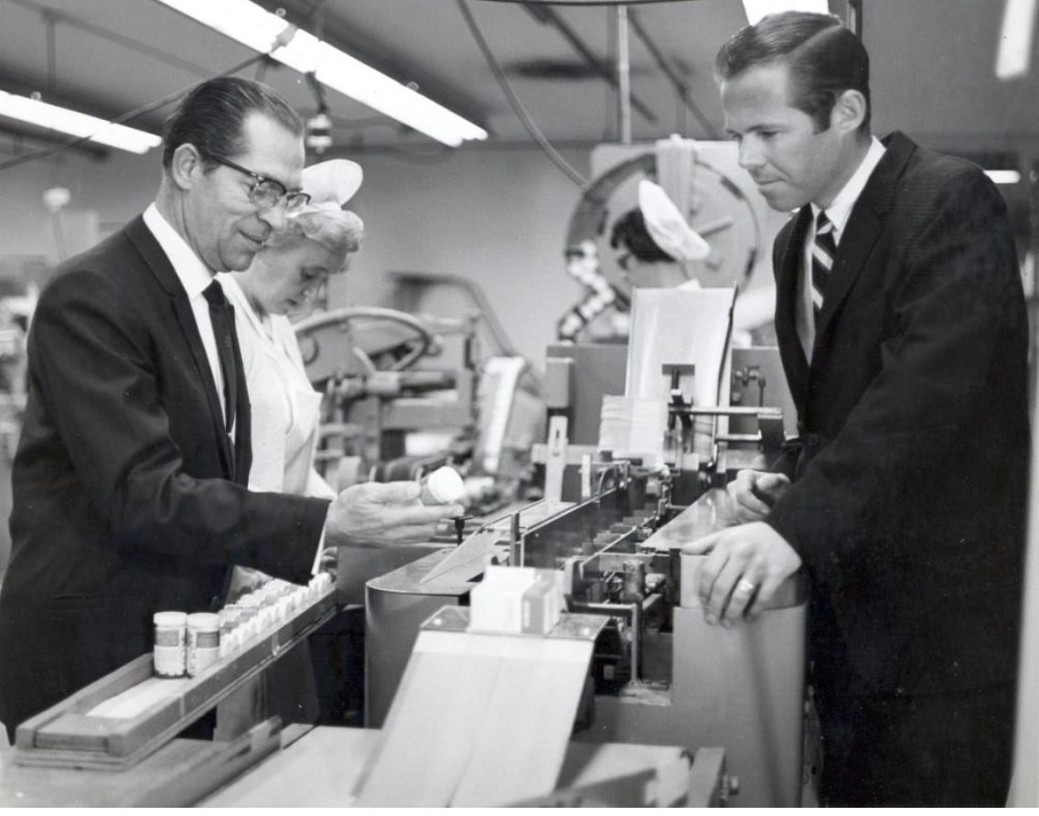 Stefan Tenkoff, Ph.D. inspects a product coming off a packaging line as I look on. Buena Park, Calif. Circa 1965.