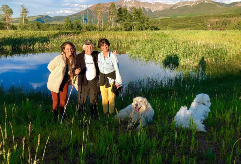 Family hiking with dogs in the mountains