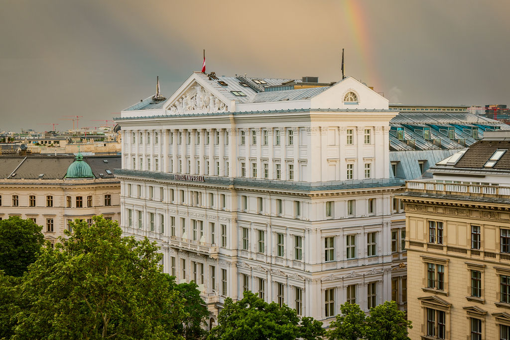 An ornate historic building with a rainbow above it.